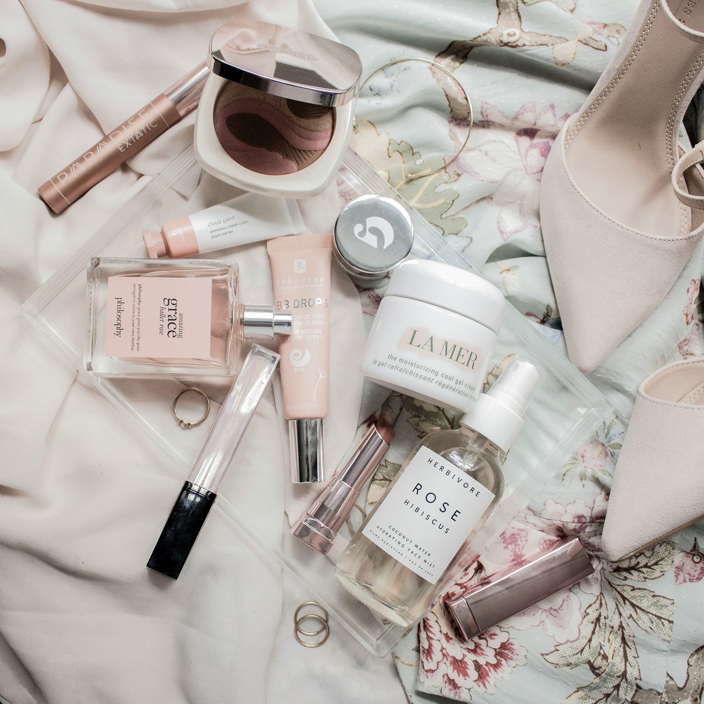 Perfume and skincare arranged on fabric